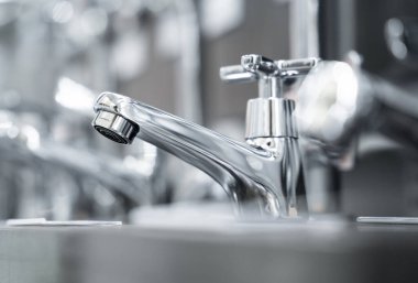 Rows of metal water taps at the showroom of a large store.