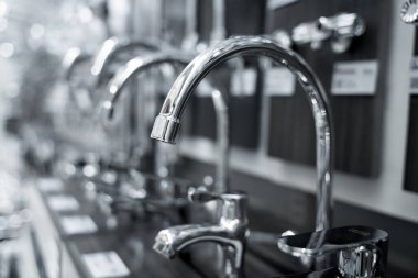 Rows of metal water taps at the showroom of a large store.