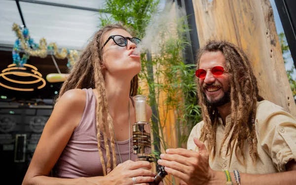 Hippie Style Couple Smoking Medical Marijuana Using Bong — 스톡 사진