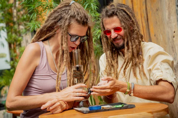 Hippie Style Couple Smoking Medical Marijuana Using Bong — Foto Stock