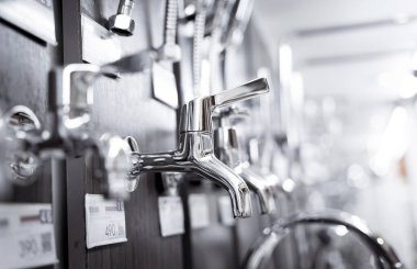Rows of metal water taps at the showroom of a large store.