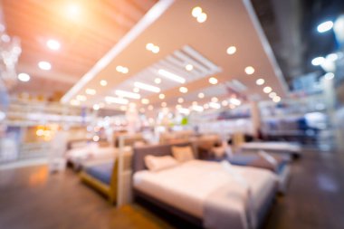 Blurred background of large household appliances and furniture store.