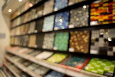 Bloored background of colorful samples of a ceramic tile.