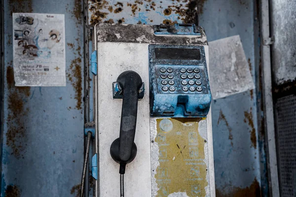 Old and dirty street phones at the city landfill.