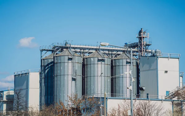 Modern silos for storing grain harvest at the blue sky background