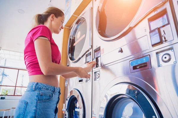 Ung Kvinna Att Sätta Mynt Tvättmaskin Vid Tvätt — Stockfoto