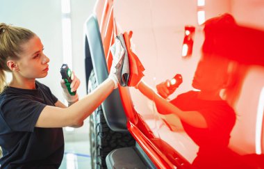 Araba temizleme işçisi mikrofiber bez ve süpürge ile araba temizleme ve cilalama