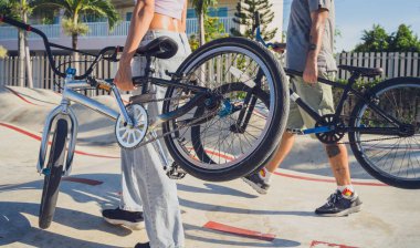 Genç mutlu çift kaykay parkında BMX 'in tadını çıkarıyor..