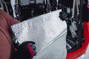 Tunning servis çalışanı arabanın içine ses yalıtımı malzemesi yükle.