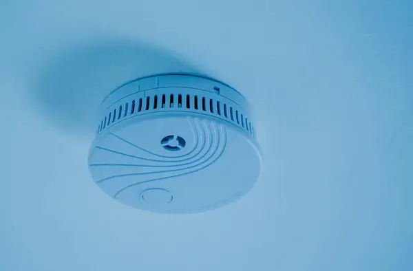 Fire safety detector on the ceiling in a modern apartment.