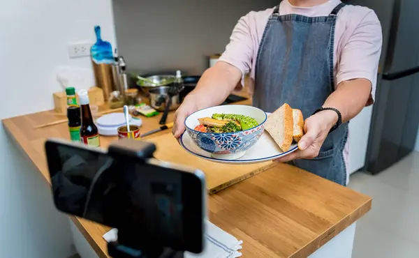 stock image The chef is broadcasting live from workshop how to prepare a vegetarian food.