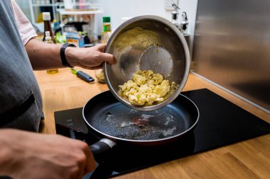 Şef mutfakta karnabahar ve sebzeli fasulye lapası hazırlıyor..