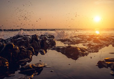 Okyanus dalgalarıyla çevrili büyük bir kaya..