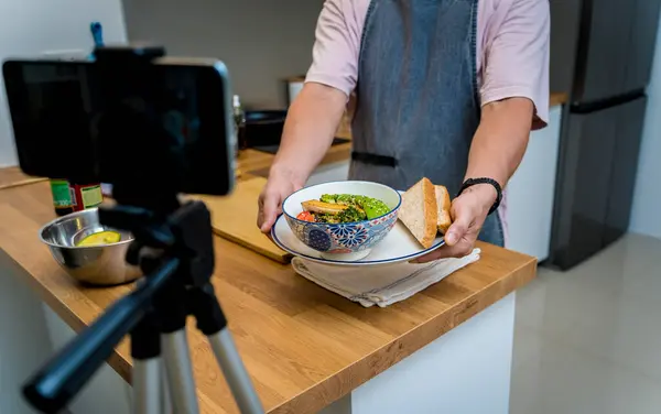 stock image The chef is broadcasting live from workshop how to prepare a vegetarian food.