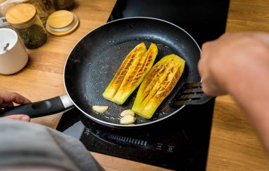 Şef mutfakta ızgara patlıcan ve sarımsak hazırlıyor..