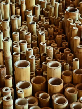 Background of bamboo tubes are arranged in a stack on top of one another. clipart