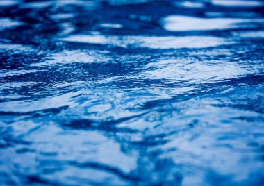 Mavi okyanus dalgalarının detaylı bir su yüzeyi görüntüsü..