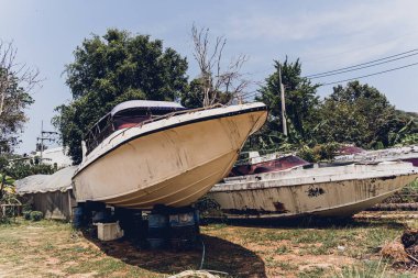 Tropikal ormanlarla çevrili eski ve paslı motorlu tekneler..