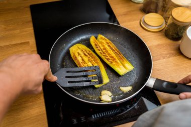 Şef mutfakta ızgara patlıcan ve sarımsak hazırlıyor..