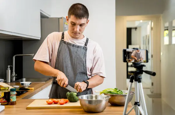 stock image The chef is broadcasting live from workshop how to prepare a vegetarian food.