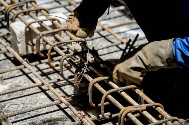 Bir grup inşaatçı metal bir yapı inşa etmekle meşgul..