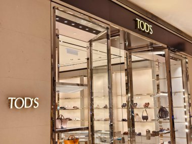 KUALA LUMPUR, MALAYSIA - AUGUST 28, 2024: Tods brand retail shop in the large shopping mall. clipart