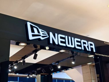 KUALA LUMPUR, MALAYSIA - AUGUST 28, 2024: Newera brand retail shop in the large shopping mall. clipart