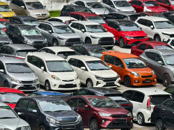 There are a great number of cars parked in a large parking lot.