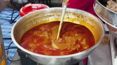 Usta bir aşçı dışarıda Tayland mutfağını tutkuyla pişiriyor.. 