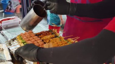 Usta bir aşçı dışarıda Tayland mutfağını tutkuyla pişiriyor.. 