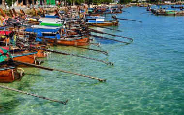 Canlı, pitoresk bir plaj sahnesi Renkli tekneler ve güneşli kumlu bir kıyı şeridi
