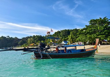 Canlı, pitoresk bir plaj sahnesi Renkli tekneler ve güneşli kumlu bir kıyı şeridi