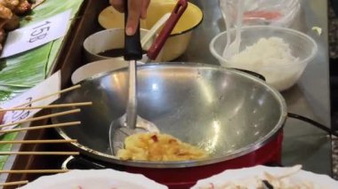 Usta bir aşçı dışarıda Tayland mutfağını tutkuyla pişiriyor.. 