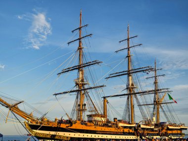 Güzel mavi gökyüzünün altında, uzun rıhtımda büyük eski bir gemi.