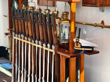 A beautiful row of decorative rifles is lined up on a wooden rack clipart