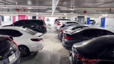 Birbirine yakın arabalarla dolu hareketli bir otopark..