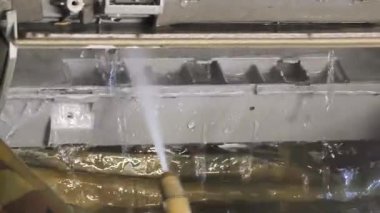 Bir teknisyen duvara monte edilmiş klimayı duruluyor ve havalandırma sistemini tamir ediyor..