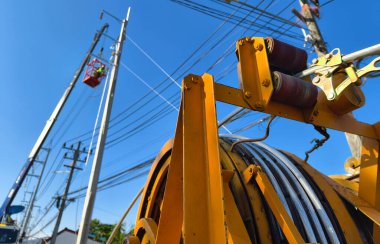 Yol boyunca yeni direklere yüksek gerilimli elektrik kabloları kurulumu.