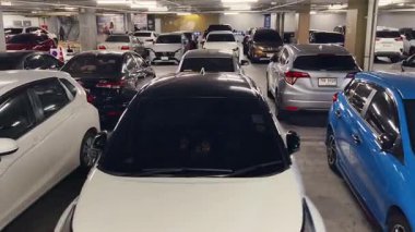 Birbirine yakın arabalarla dolu hareketli bir otopark..