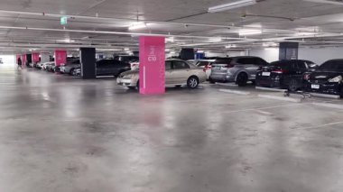 Birbirine yakın arabalarla dolu hareketli bir otopark..