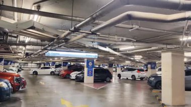 Birbirine yakın arabalarla dolu hareketli bir otopark..