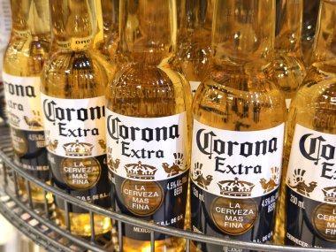 PHUKET, THAILAND - 8 Mart 2025: Corona biraları düzgünce bir rafa dizildi.