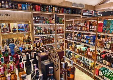 PHUKET, THAILAND - 8 Mart 2025: sayısız çeşitli alkol şişeleriyle dolu bir perakende mağazası.