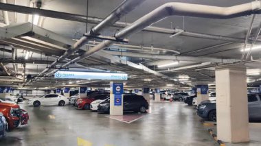 Birbirine yakın arabalarla dolu hareketli bir otopark..