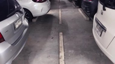 Birbirine yakın arabalarla dolu hareketli bir otopark..