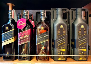 PHUKET, THAILAND - 8 Mart 2025: Bir süpermarketteki rafta Johnnie Walker 'ın viski şişeleri.