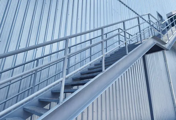 Büyük mavi bir duvara tırmanan bir merdiven seti..