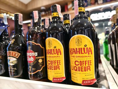 PHUKET, THAILAND - 8 Mart 2025: sayısız çeşitli alkol şişeleriyle dolu bir perakende mağazası.