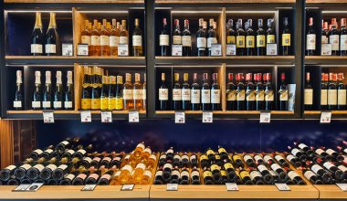 PHUKET, THAILAND - 8 Mart 2025: Çok sayıda şarap şişesi ve kutu içeren bir mağaza.