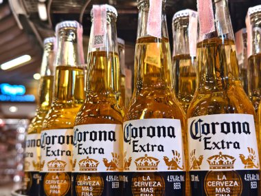 PHUKET, THAILAND - 8 Mart 2025: Corona biraları düzgünce bir rafa dizildi.